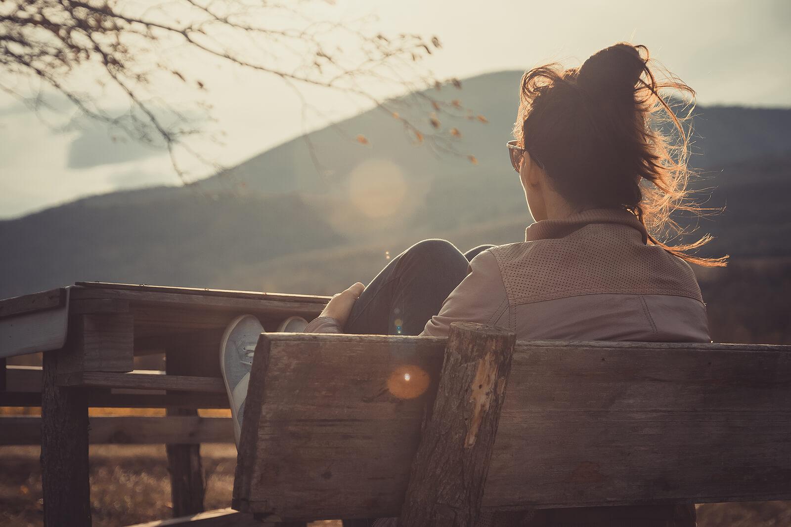 Image of a thoughtful woman sitting on a bench. Face your depression symptoms to create a healthier more fulfilling life with the support of an adult IOP in Houston, TX.