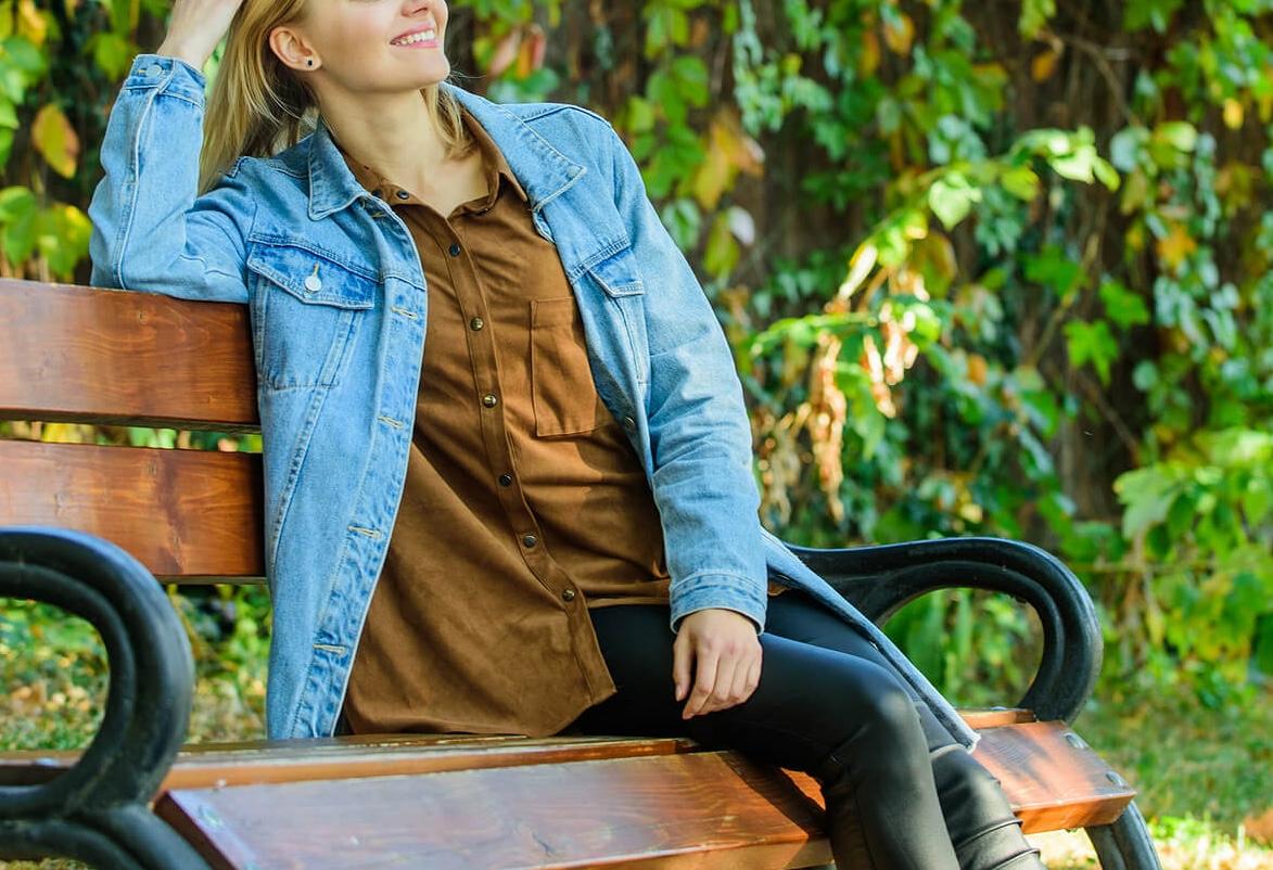 Image of a blonde woman sitting on a park bench smiling and looking relaxed. With the support of an adult intensive outpatient program in Houston, TX you can begin working on coping and managing with your BPD symptoms in positive ways.