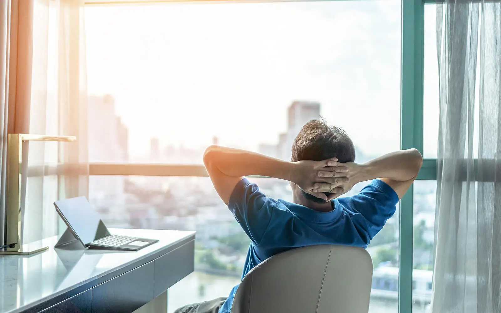 Image of a relaxed man leaning back in a chair looking out a window. Learn to acknowledge your thoughts, emotions, or distractions with the help of mindfulness at an adult intensive outpatient program in Houston, TX.