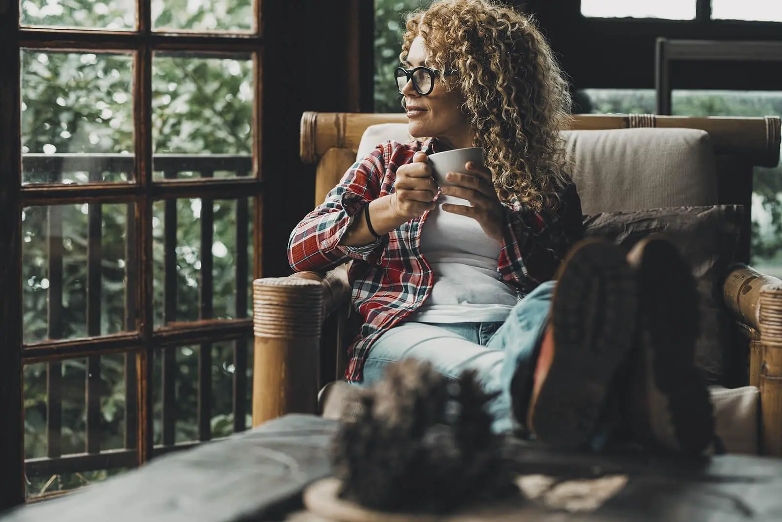relaxed woman in chair | adult iop in houston, tx | adult intensive outpatient program in houston, tx | iop for depression | adult outpatient program | 77056 | 77005 | 77006 Image of a relaxed middle aged woman sitting in a chair holding a coffee mug. Begin healing from your symptoms with support and start coping in positive ways with adult IOP in Houston, TX.