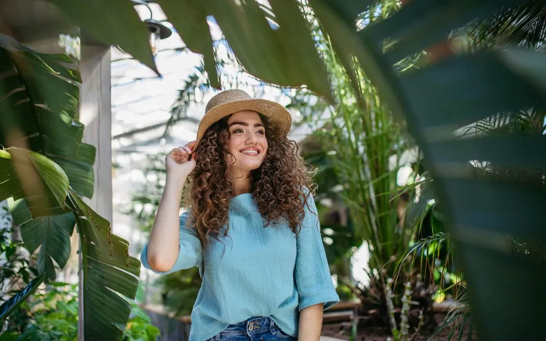 Image of a smiling young woman walking through botanical garden. Find support finding peace and healing with the help of an adult IOP in Houston, TX.
