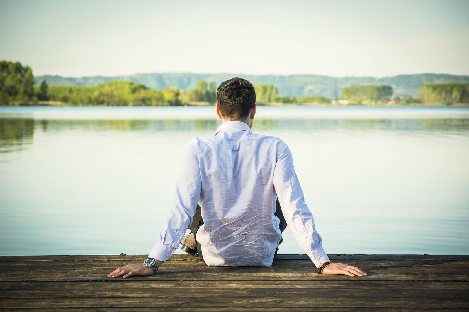 man on pier | adult iop in houston, tx | adult intensive outpatient program in houston, tx | intensive outpatient program houston | iop program houston | 77008 | 77009 | 77018 Relaxed man sitting on a wooden pier next to a lake. If you are feeling stuck and in the same unhealthy patterns, find support in coping and overcoming those patterns with DBT i an adult intensive outpatient program in Houston, TX.