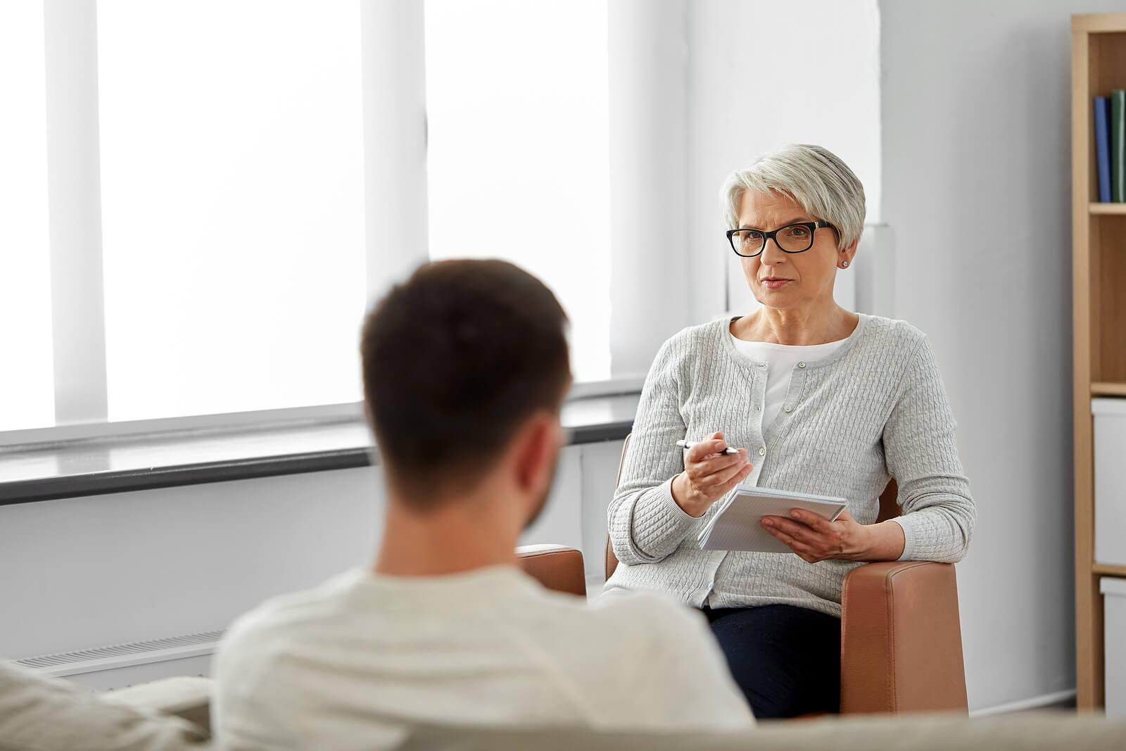 man with therapist | adult intensive outpatient program in houston, tx | adult iop | iop for rsd | intensive outpatient program houston | 77056 | 77005 | 77006 Image of a female therapist listening to a male client. By learning DBT in an adult intensive outpatient program in Houston, TX you can begin to manage and overcome your rejection sensitive dysphoria.
