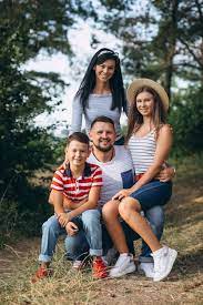 images parents and 2 children together in nature, sitting