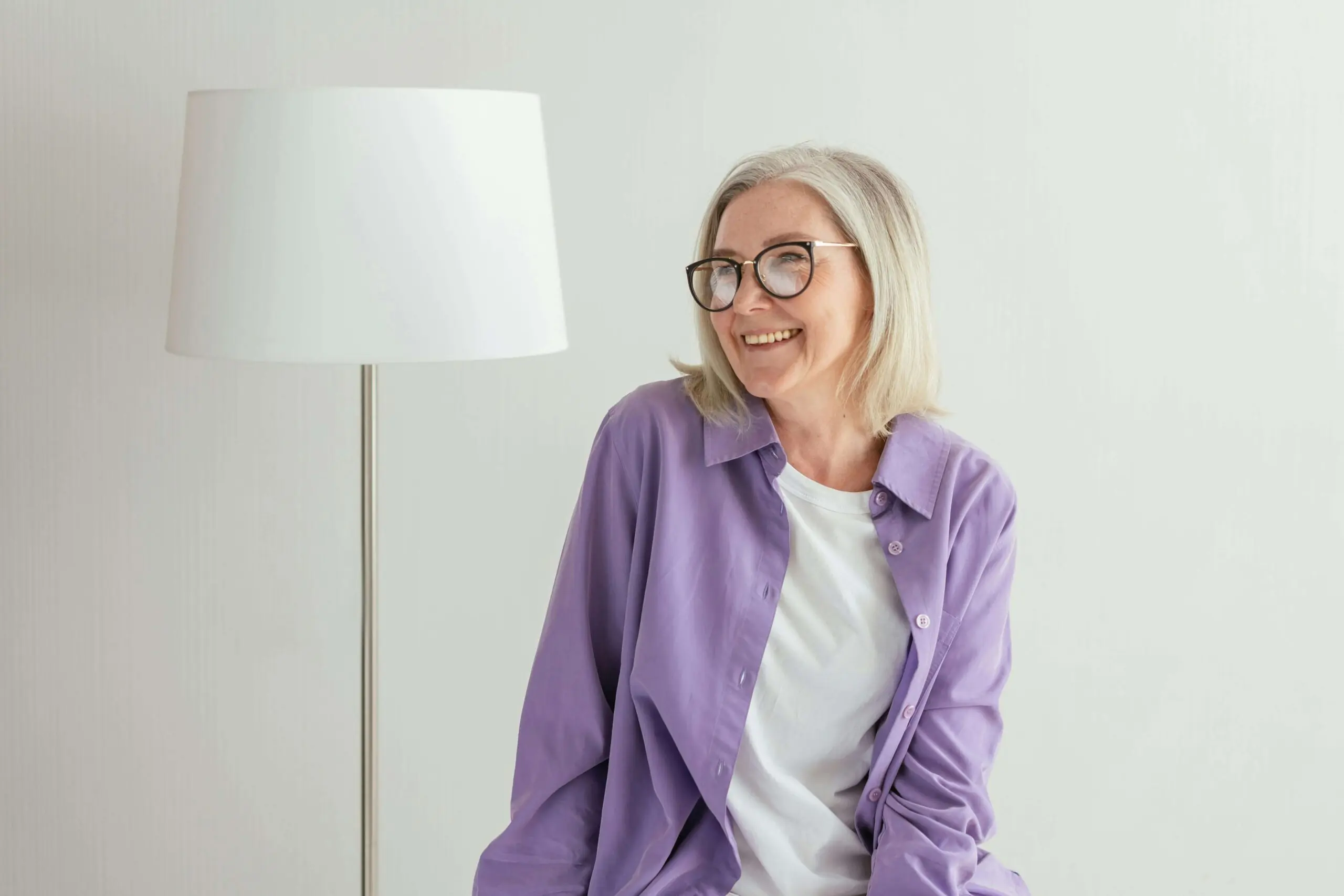 Smiling mature woman wearing a purple shirt. Begin healing and overcoming the negative unhealthy patterns keeping you from moving forward with an adult IOP in Houston, TX.