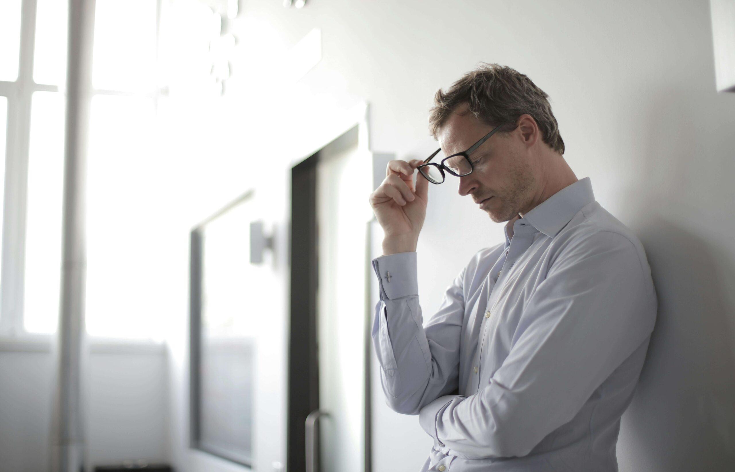 stressed man | adult intensive outpatient program in houston, tx | adult iop | iop for rsd | intensive outpatient program houston | 77022 | 77024 | 77057 Image of a stressed business man standing in the hallway with his eyes closed. Find support when it comes to overcoming rejection sensitivty dysphoria with an adult intensive outpatient program in Houston, TX.