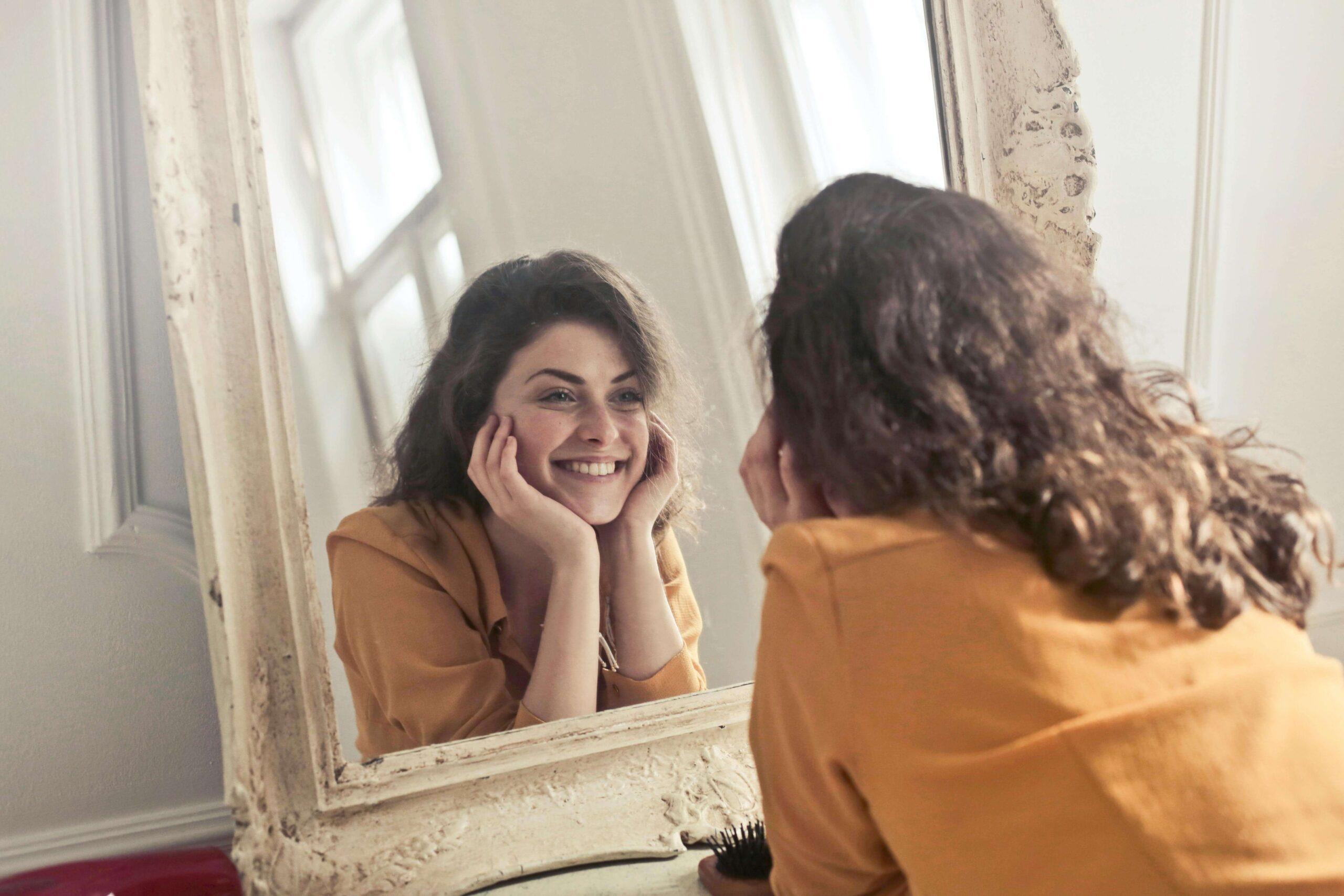 woman looking in mirror | adult intensive outpatient program in houston, tx | adult iop | intensive outpatient program houston | adult outpatient program | 77056 | 77005 | 77006 Image of a smiling woman laying on the ground looking into a mirror. Self harm can be difficult to cope with on your own but with the support of an Adult IOP in Houston, TX you can learn the healthy ways to cope.