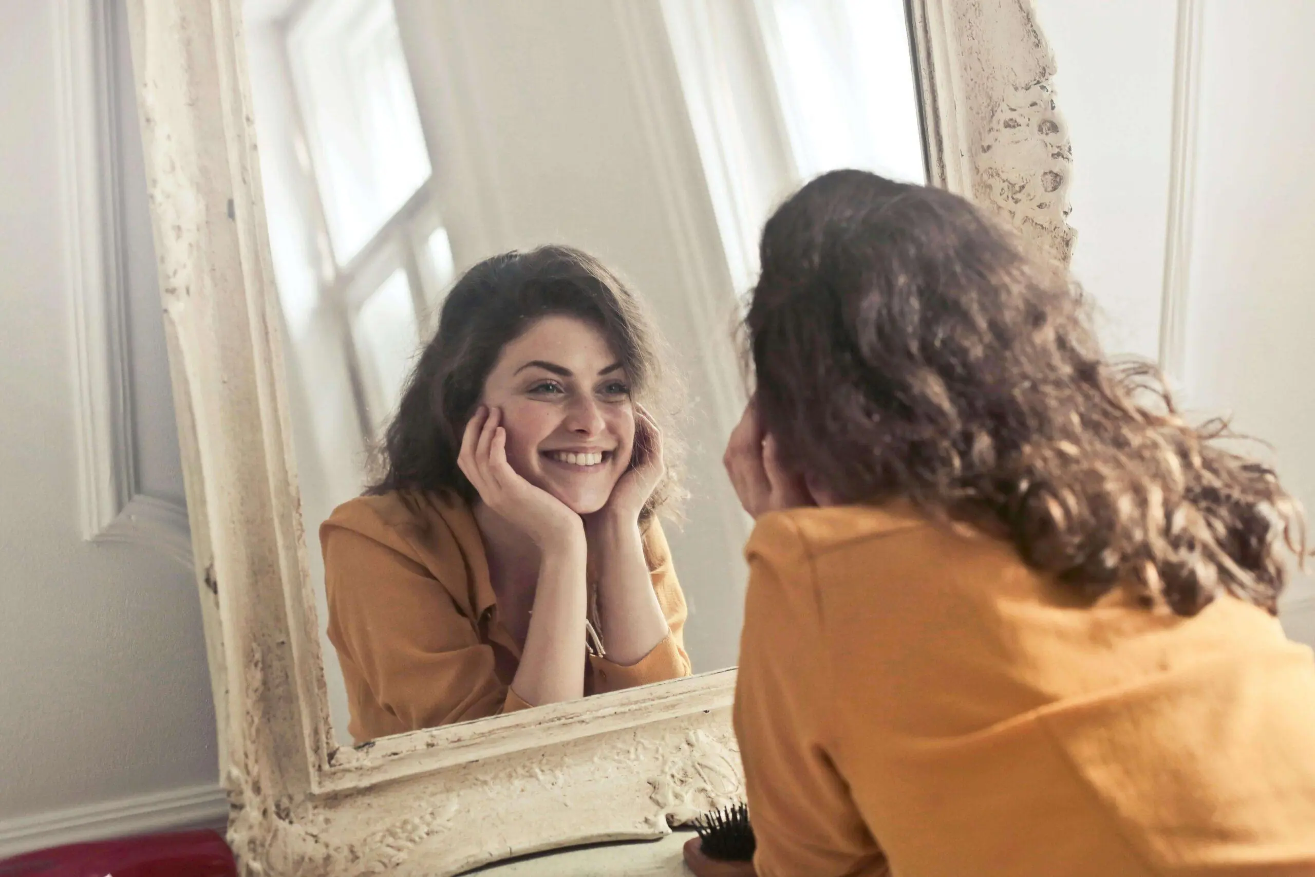 woman looking in mirror | adult intensive outpatient program in houston, tx | adult iop | intensive outpatient program houston | adult outpatient program | 77056 | 77005 | 77006 Image of a smiling woman laying on the ground looking into a mirror. Self harm can be difficult to cope with on your own but with the support of an Adult IOP in Houston, TX you can learn the healthy ways to cope.