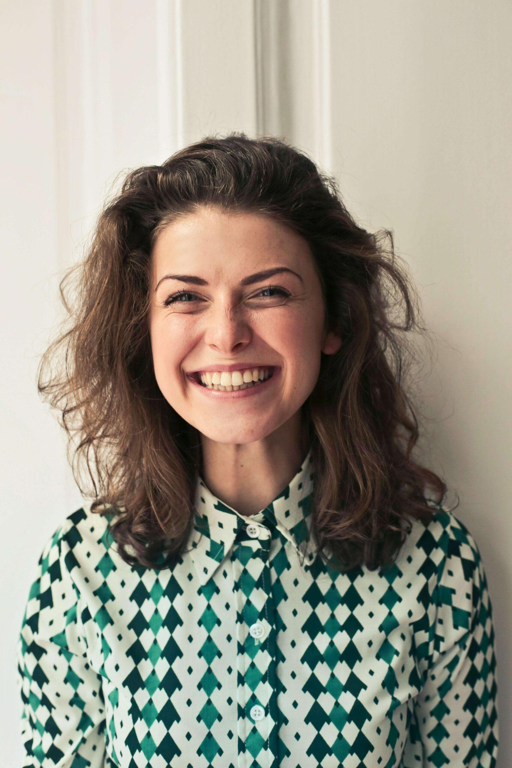 smiling woman | adult intensive outpatient program in houston, tx | adult iop | iop for rsd | intensive outpatient program houston | 77007 | 77055 | 77057 Image of a woman smiling in a patterned green shirt. Learn effective DBT skills in an adult intensive outpatient program in Houston, TX to help you manage and overcome your symptoms to help promote healing.
