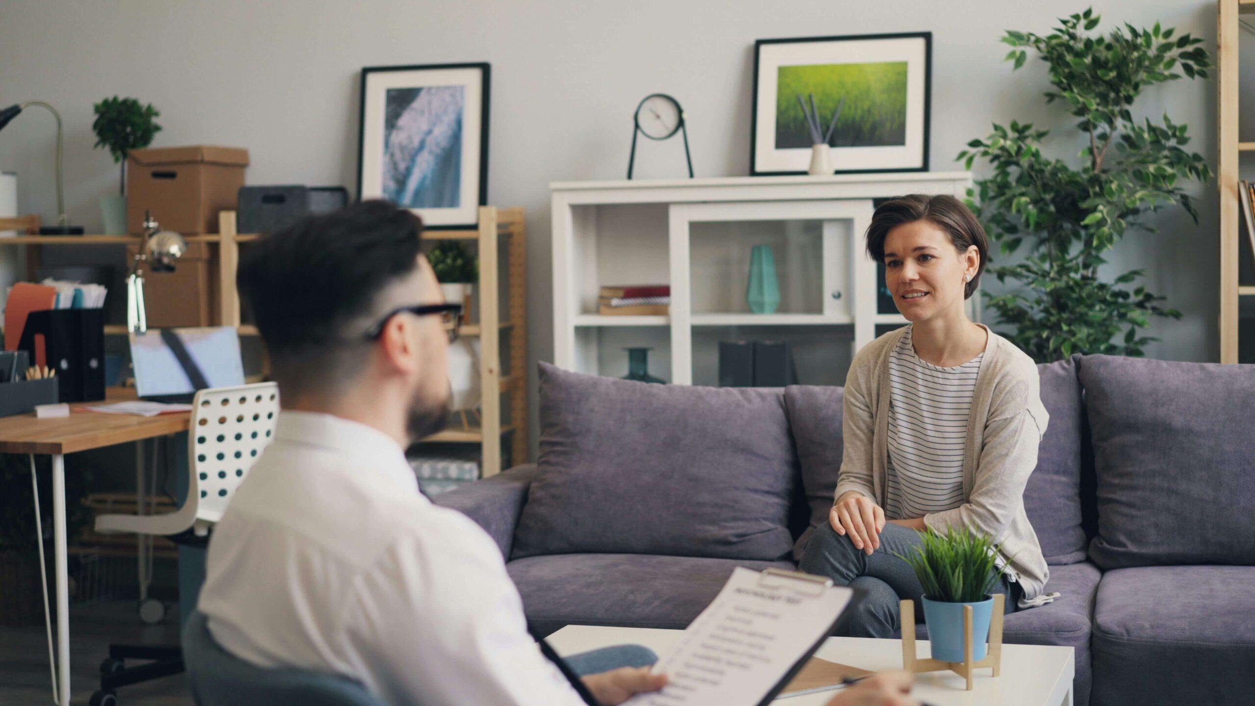 woman in therapy | adult intensive outpatient program in houston, tx | adult iop | intensive outpatient program houston | adult outpatient program | 77022 | 77024 | 77057 Woman sitting on a couch speaking as a male therapist sits across from her and listens. If you struggle with your emotions and are looking to heal from self harm, an adult intensive outpatient program in Houston, TX can help you begin to cope in healthy ways.