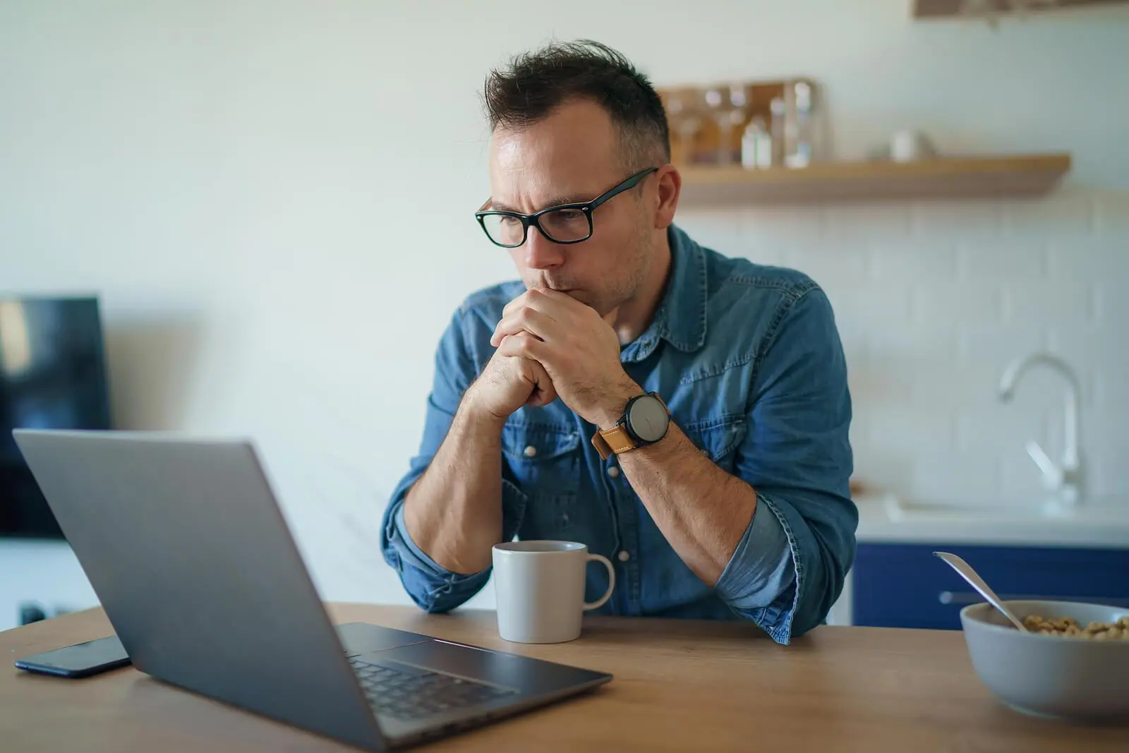 thoughtful man with laptop | perfectionism treatment in houston, tx | ocpd perfectionism | overcoming perfectionism | coping with perfectionism | Montrose | Afton Oaks | Boulevard Oaks Thoughtful man sitting at a table looking at a laptop. Don't struggle on your own with perfectionism and OCPD. With the help of perfectionism treatment in Houston, TX you can learn to reduce your anxiety in positive ways.