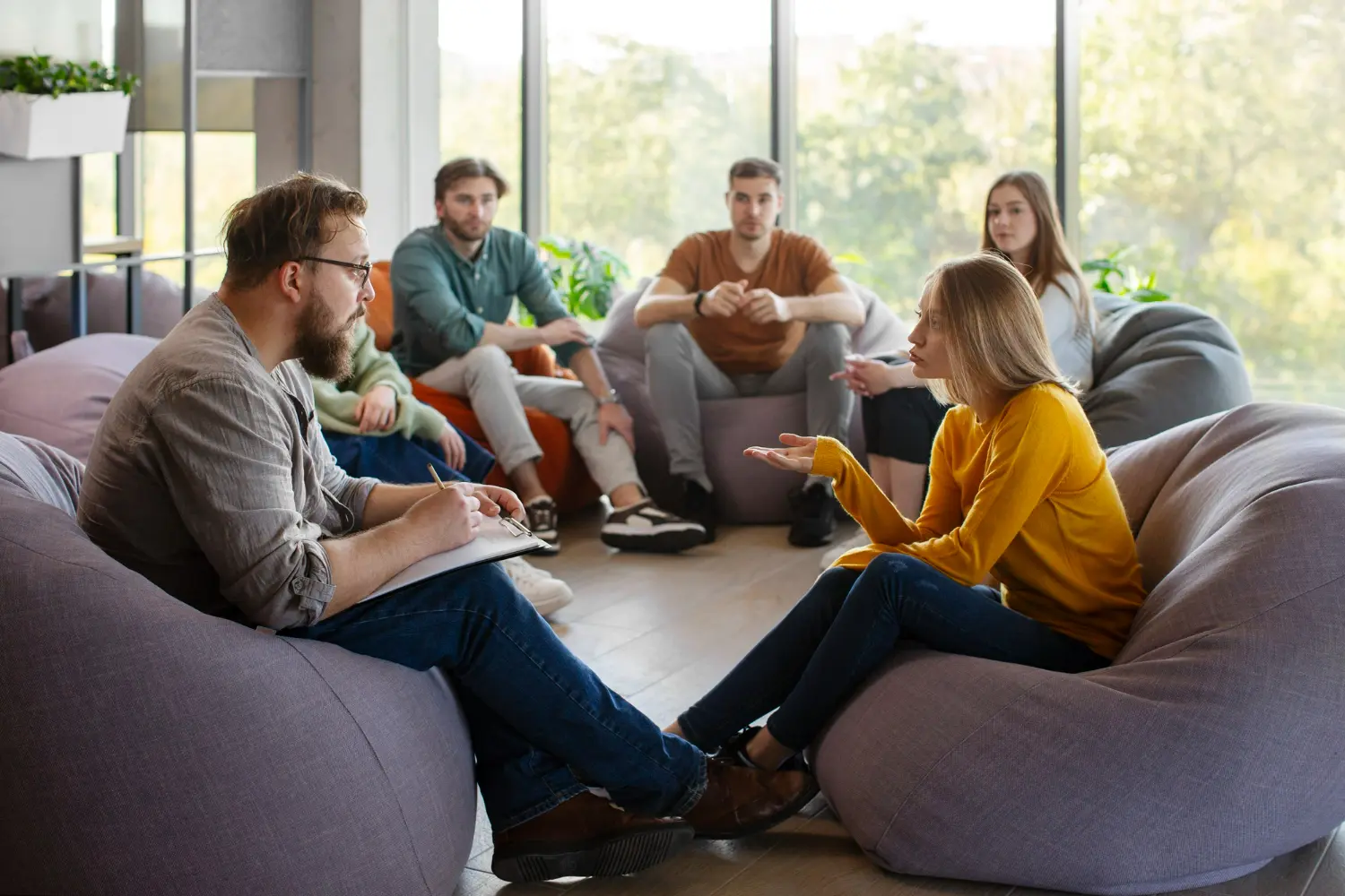 Men and Women sitting around a table, support group