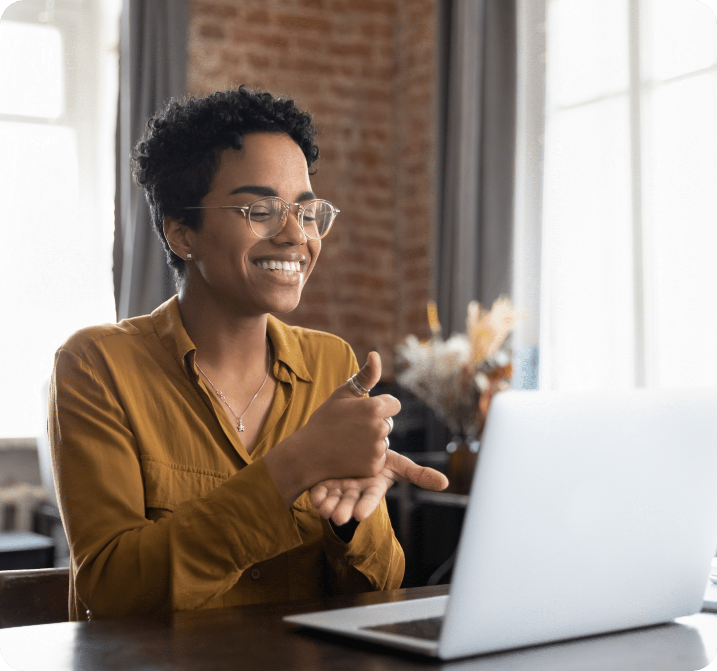 Woman of color talking in front of computer